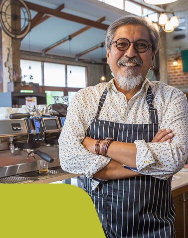 A hospitality worker smiling to camera A hospitality worker smiling to camera